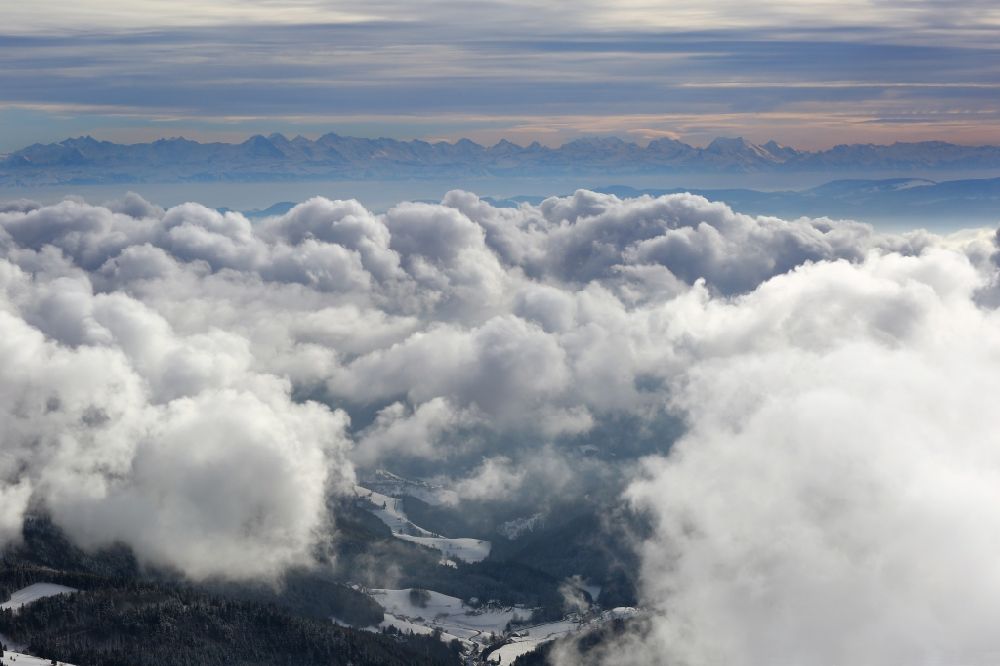 Aerial image Kleines Wiesental - Weather conditions with cloud formation over the Kleines Wiesental in the Black Forest in Baden - Wuerttemberg . Snow-covered Black Forest mountains and panoramic view over the cloud cover up to the Swiss Alps