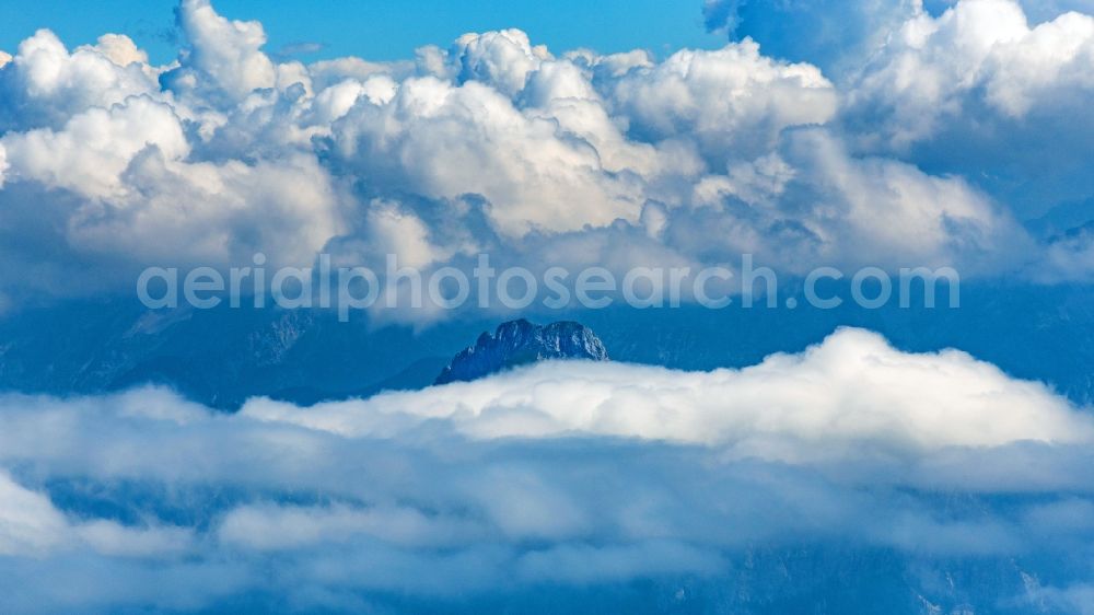 Höfen from above - Weather conditions with cloud formation above the mountain peaks of the Alps in Hoefen in Tirol, Austria