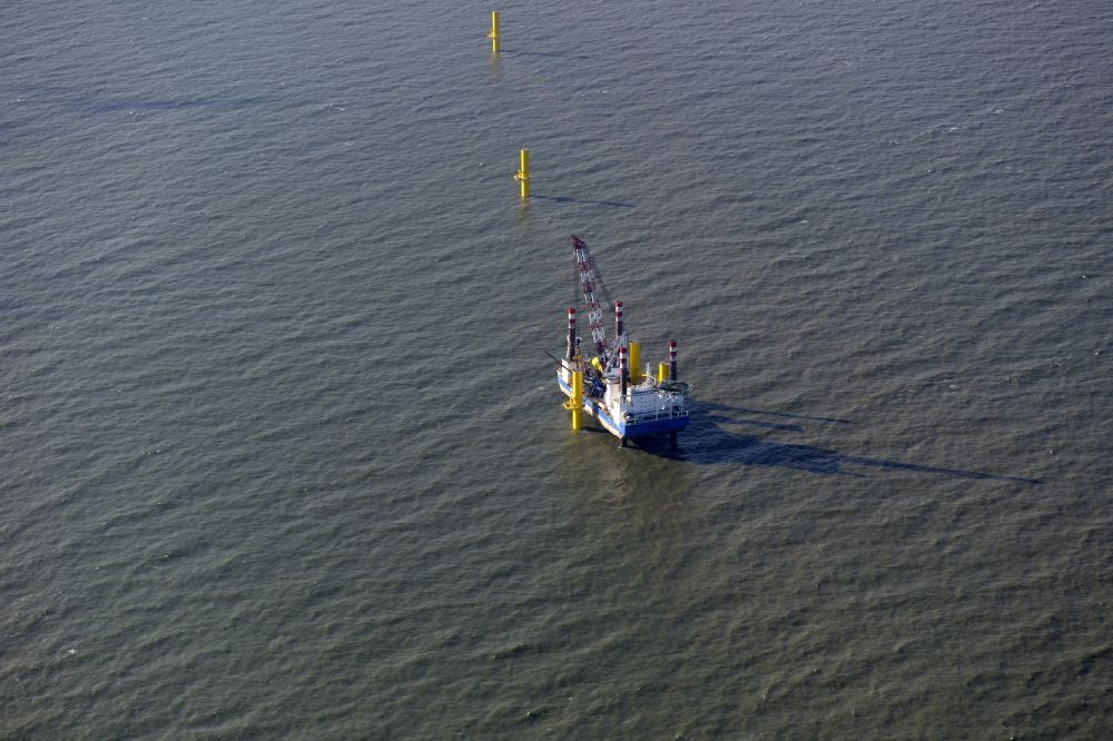 Wangerland from the bird's eye view: Windenergieanlagen (WEA) under construction in the North Sea Aussenweser near Wangerland. MPI Enterprise special vessel for the construction of offshore wind energy turbines (WTD)