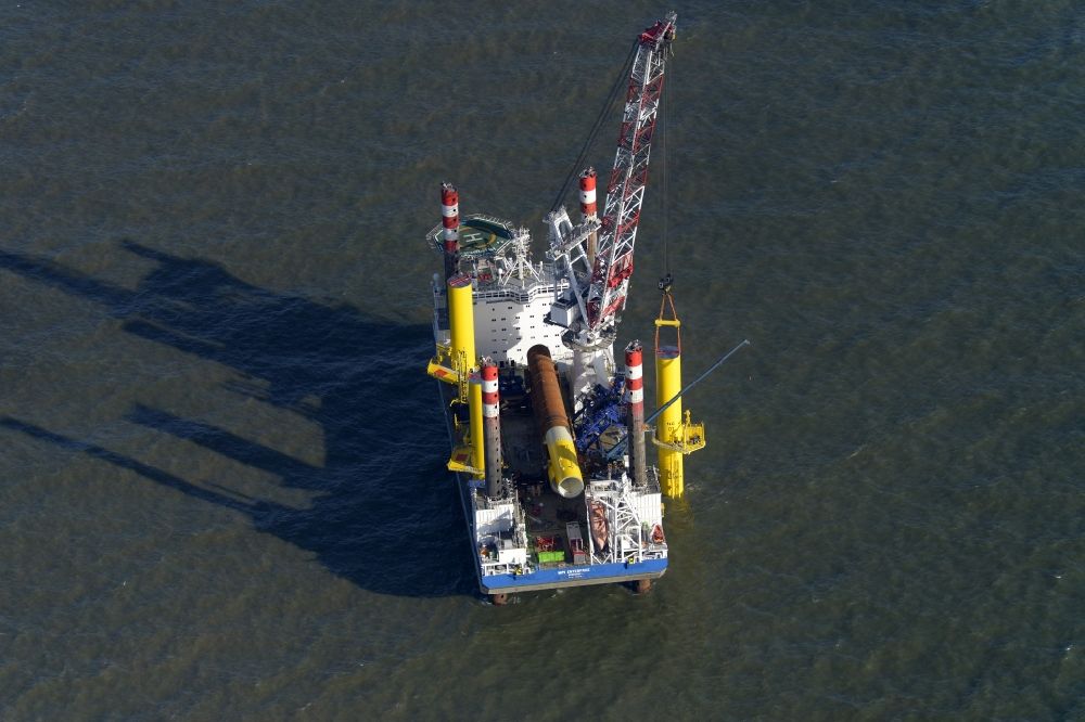 Aerial image Wangerland - Windenergieanlagen (WEA) under construction in the North Sea Aussenweser near Wangerland. MPI Enterprise special vessel for the construction of offshore wind energy turbines (WTD)