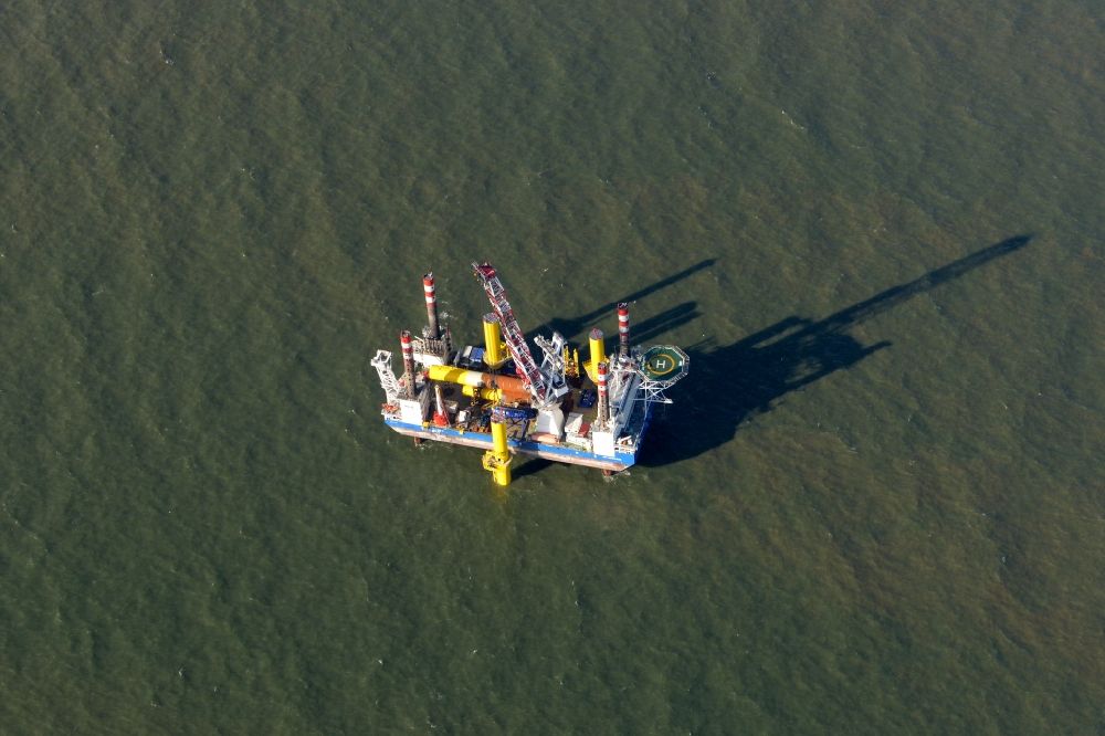 Aerial image Wangerland - Windenergieanlagen (WEA) under construction in the North Sea Aussenweser near Wangerland. MPI Enterprise special vessel for the construction of offshore wind energy turbines (WTD)