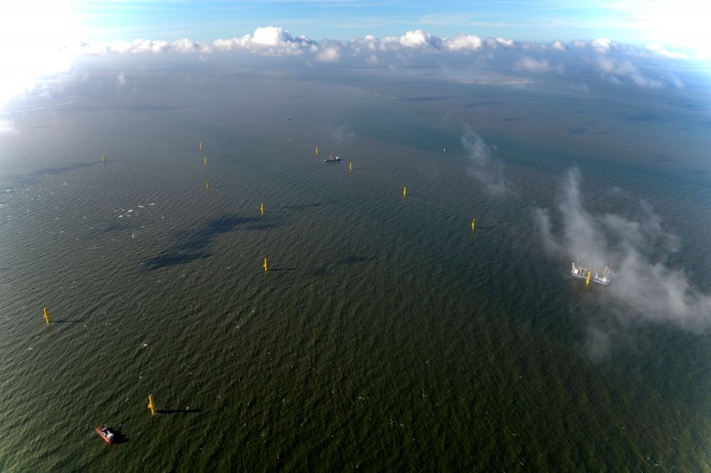 Aerial photograph Wangerland - Windenergieanlagen (WEA) under construction in the North Sea Aussenweser near Wangerland. MPI Enterprise special vessel for the construction of offshore wind energy turbines (WTD)