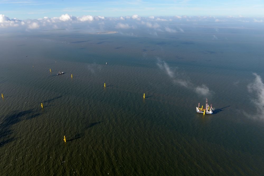 Wangerland from above - Windenergieanlagen (WEA) under construction in the North Sea Aussenweser near Wangerland. MPI Enterprise special vessel for the construction of offshore wind energy turbines (WTD)
