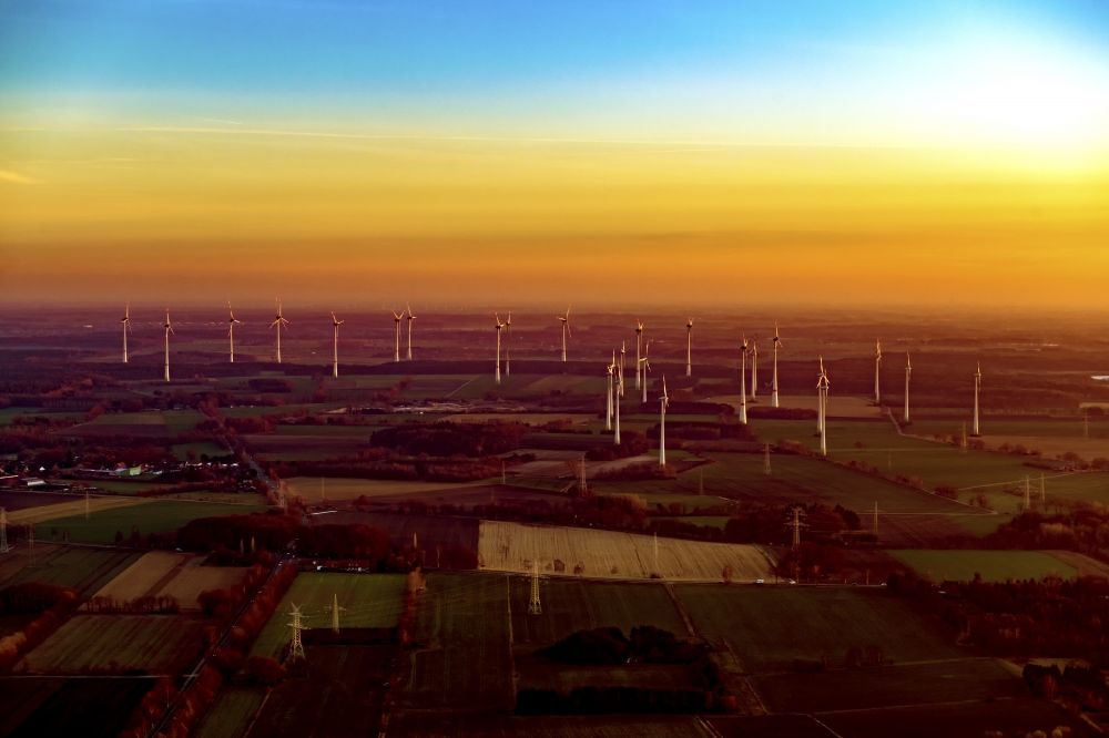 Bargstedt from the bird's eye view: Wind energy plants (WEA) in the sunset - wind turbine - on a field in Stade Helmste in the state Lower Saxony, Germany