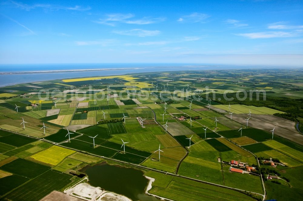 Aerial image Niebüll - Wind power wheels and turbines in the county district of Nordfriesland in the state of Schleswig-Holstein. The turbines are placed between fields. Overview of the agricultural structures as well as the wheels used to create energy