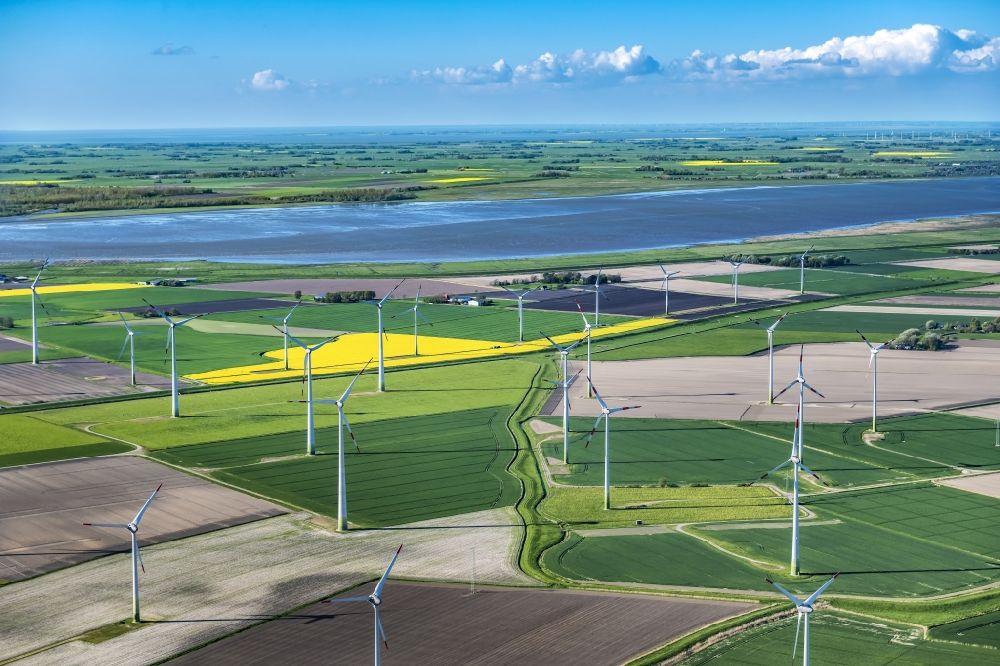 Aerial image Wesselburen - Wind power wheels and turbines in Wesselburen of Schleswig-Holstein. The turbines are placed between fields. Overview of the agricultural structures as well as the wheels used to create energy