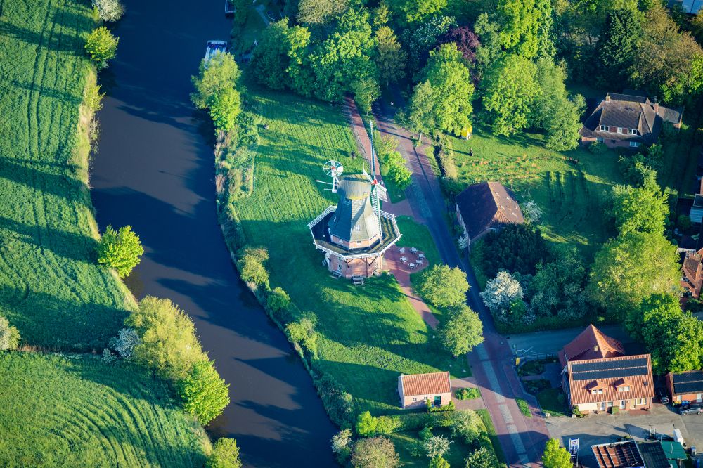Krummhörn from the bird's eye view: Historic Windmill Green Mill in Greetsiel in the state Lower Saxony, Germany