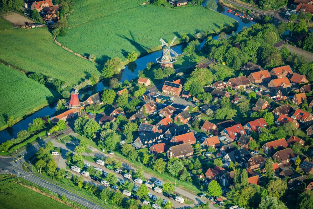 Aerial image Greetsiel - Historical windmills Green and Red at the Alten Greetsieler Sieltief in Greetsiel in the state Lower Saxony, Germany