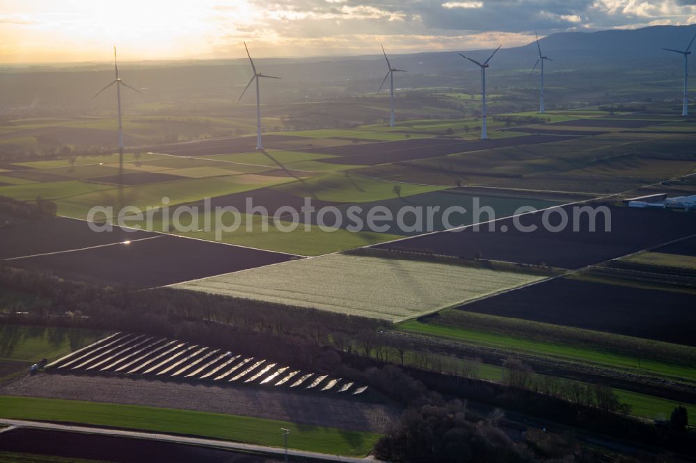 Aerial image Freckenfeld - Wind turbine windmills on a field in Freckenfeld before a field with rows of photo-voltaic cells in the state Rhineland-Palatinate, Germany