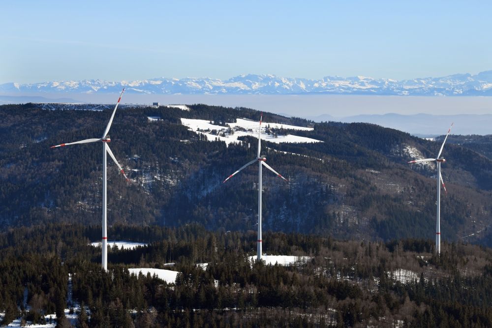 schopfheim from the bird's eye view: Looking over the wind turbines of the wind farms in the Southern Black Forest in Hasel, Baden-Wurttemberg. At the horizon the snow covered Swiss Alps