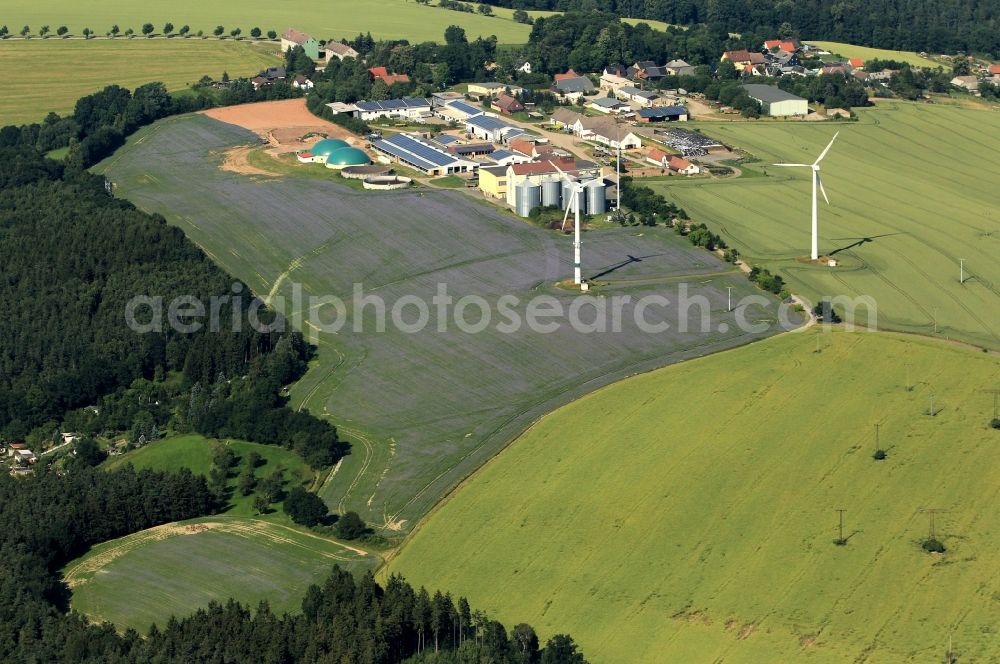Aerial image Berga/Elster - Markersdorf is a district in Berga / Elster in Thuringia. The agricultural cooperative Elster Markersdorf eG here has stables. For farmers, renewable energy plays an important role. With wind turbines, solar panels on the barn roof and a biogas plant green electricity is produced here