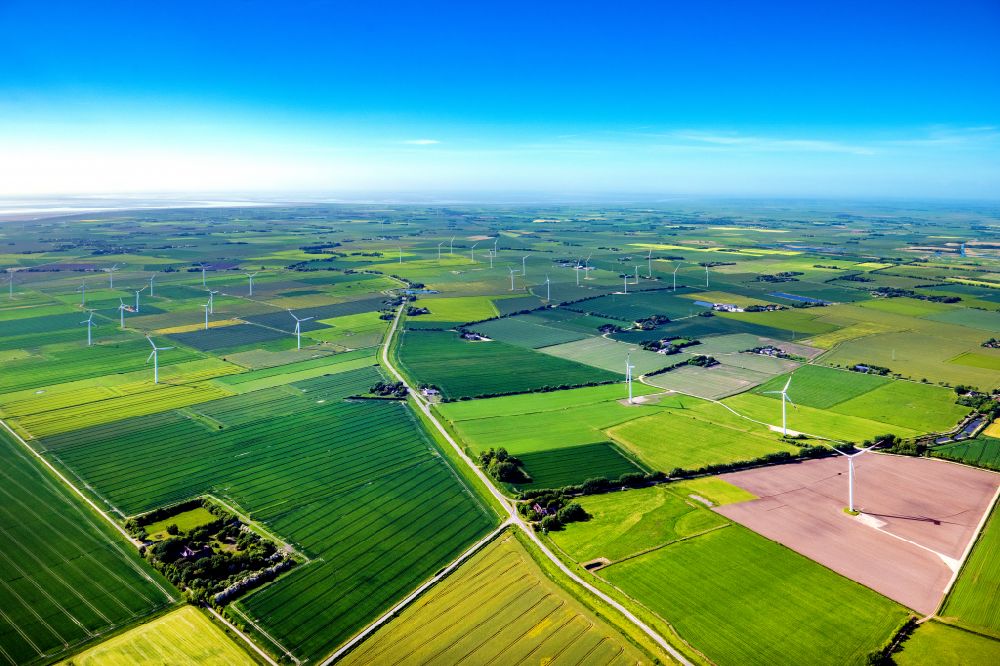 Aerial image Galmsbüll - Wind turbines of a wind power plant Gotteskoogdeich on agricultural land and fields on the edge of the settlement area of the village in Galmsbuell North Friesland in the state Schleswig-Holstein, Germany