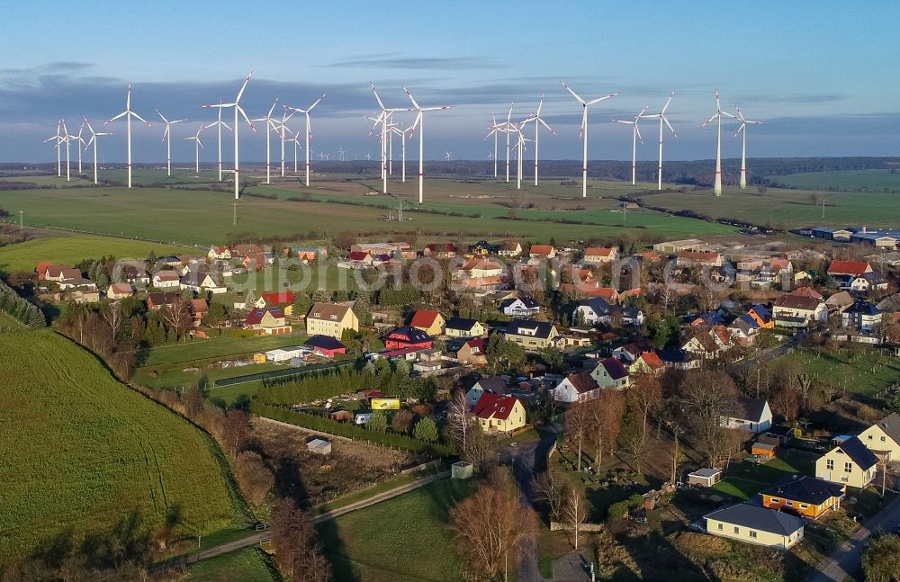 Jacobsdorf from the bird's eye view: Wind turbines of a wind power plant Windenergiepark Odervorland on agricultural land and fields on the edge of the settlement area of the village in Jacobsdorf in the state Brandenburg, Germany
