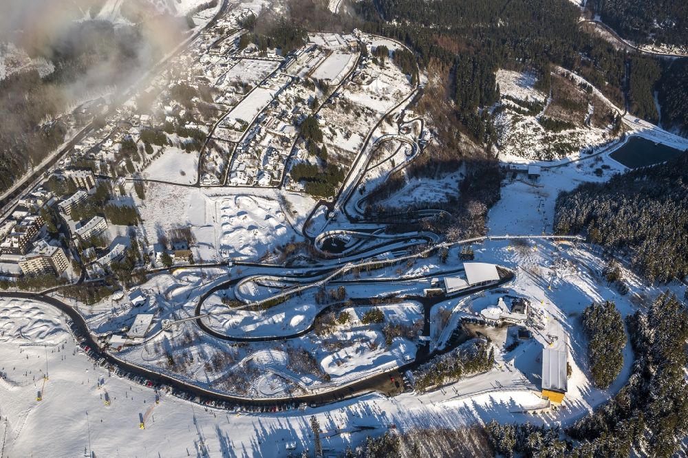 Aerial photograph Winterberg - View of the partially snow covered, foggy and cloudy winter landscape of Schmallenberg in the state of North Rhine-Westphalia. In Winterberg is the bobsleigh run Winterberg