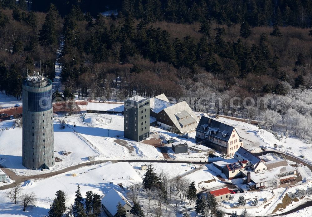 Aerial photograph Kurort Brotterode - Winter landscape of snowy mountain peak of the mountain Inselsberg with an observation tower and radio tower in Brotterode in Thuringia