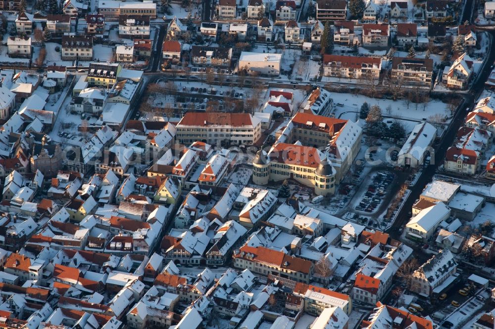 Aerial image Bad Bergzabern - Wintry snowy townscape with streets and houses of the residential areas in Bad Bergzabern in the state Rhineland-Palatinate