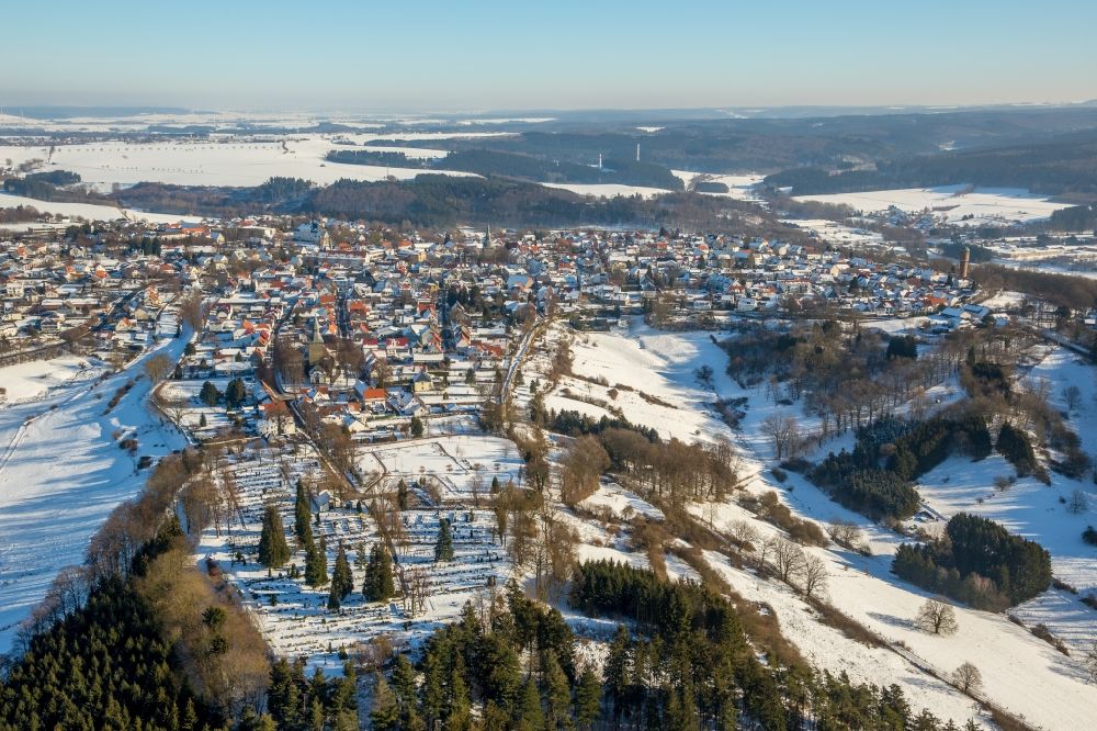 Rüthen from the bird's eye view: Wintry snowy townscape with streets and houses of the residential areas in Ruethen in the state North Rhine-Westphalia