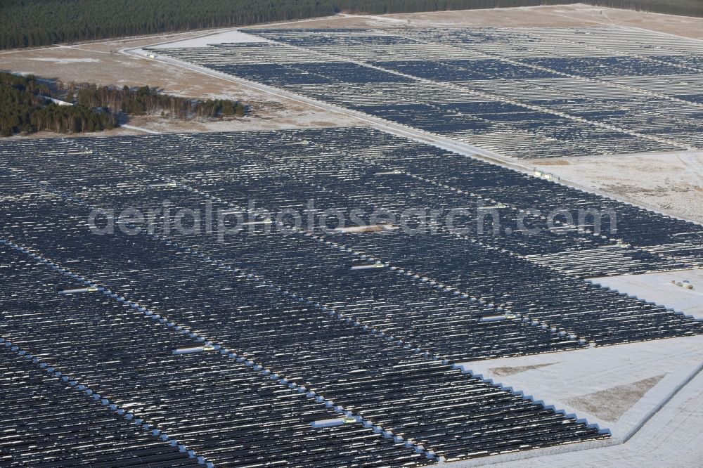 Aerial photograph Brandenburg an der Havel - Winterly snowy solar park on the former NVA airfield Brandenburg-Briest in Brandenburg an der Havel in the Federal State of Brandenburg. It is a joint project between the company of Q-cells and the investors Luxcara GmbH and the MCG group