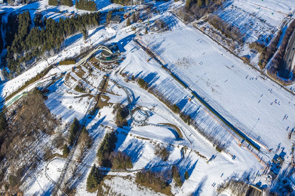 Aerial image Winterberg - Wintry snowy mountain slope with downhill ski slope and cable car - lift on Poppenberg in Winterberg at Sauerland in the state North Rhine-Westphalia, Germany