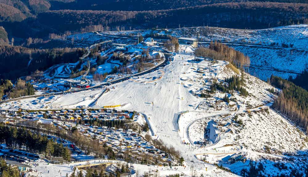 Aerial photograph Winterberg - Wintry snowy mountain slope with downhill ski slope and cable car - lift Sesselbahn Kappe in Winterberg at Sauerland in the state North Rhine-Westphalia, Germany