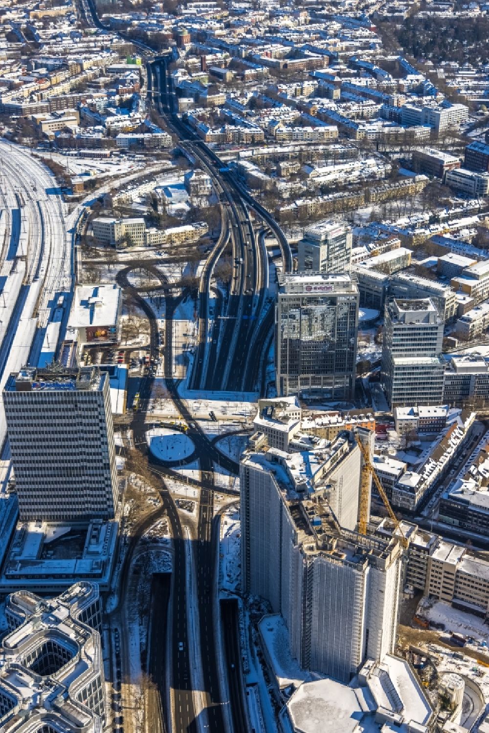 Essen from the bird's eye view: Wintry snowy dismantling of high-rise buildings of formerly RWE head quartet on street Huyssenallee in Essen at Ruhrgebiet in the state North Rhine-Westphalia, Germany