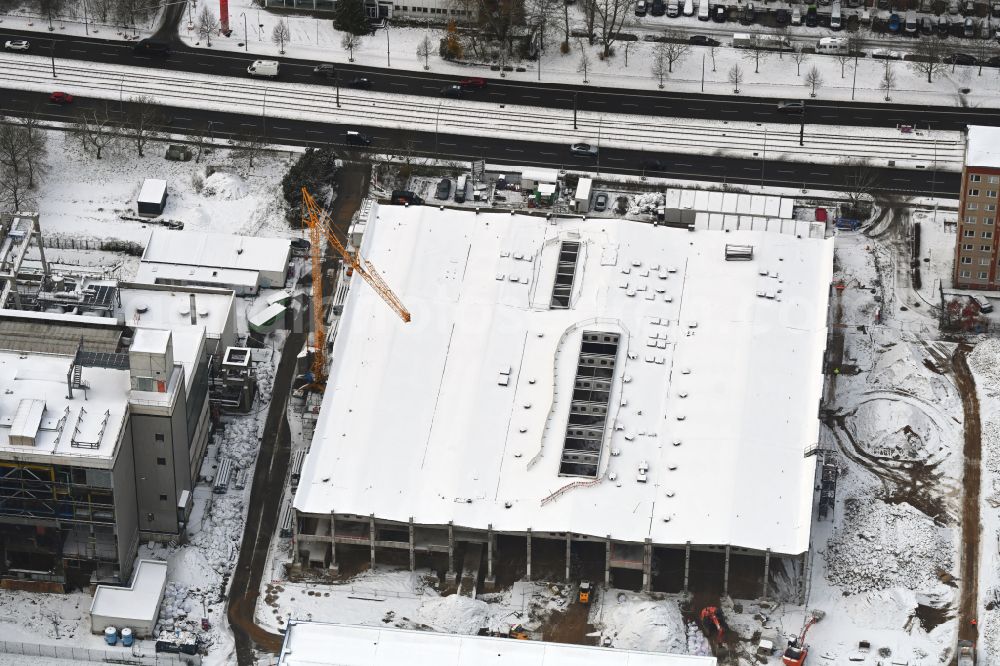 Berlin from above - Wintry snowy demolition and dismantling of the disused old power plant hall of the thermal power plant on Rhinstrasse in the Marzahn district in Berlin, Germany