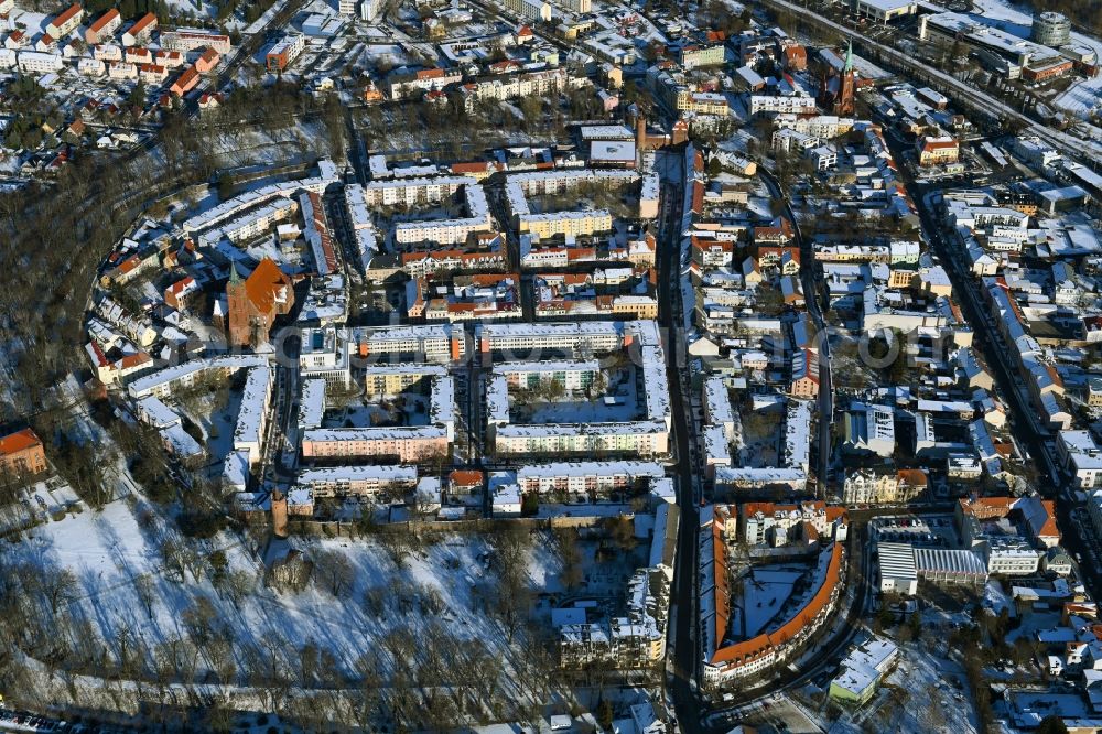 Bernau from the bird's eye view: Wintry snowy old Town area and city center in Bernau in the state Brandenburg, Germany