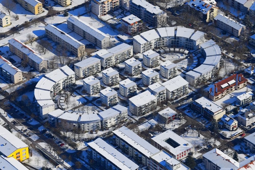 Lörrach from above - Wintry snowy residential development on the site of the former stadium in Loerrach in Baden-Wuerttemberg. The geometry of the stadium was maintained for the arrangement of the houses and blocks