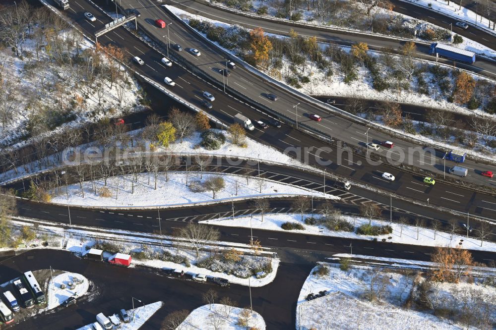 Berlin from the bird's eye view: Wintry snowy traffic flow at the intersection- motorway Funkturm A 100 - A 115 in the district Charlottenburg in Berlin, Germany