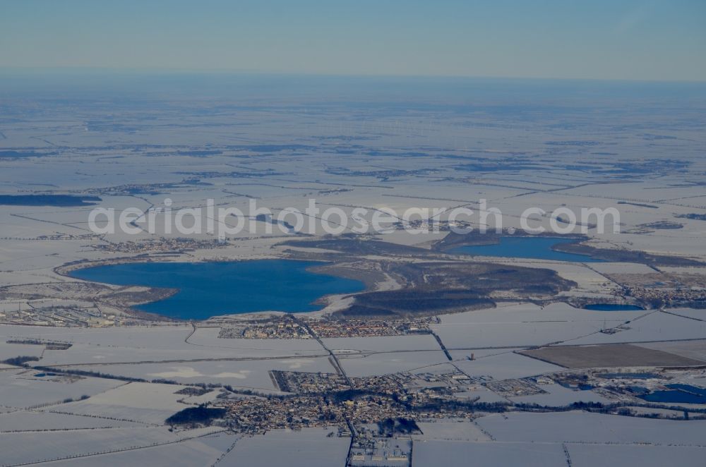 Seeland from above - Wintry snowy lake shore and overburden areas of the quarry lake and gravel open pit Concordiasee in Seeland in the state Saxony-Anhalt, Germany