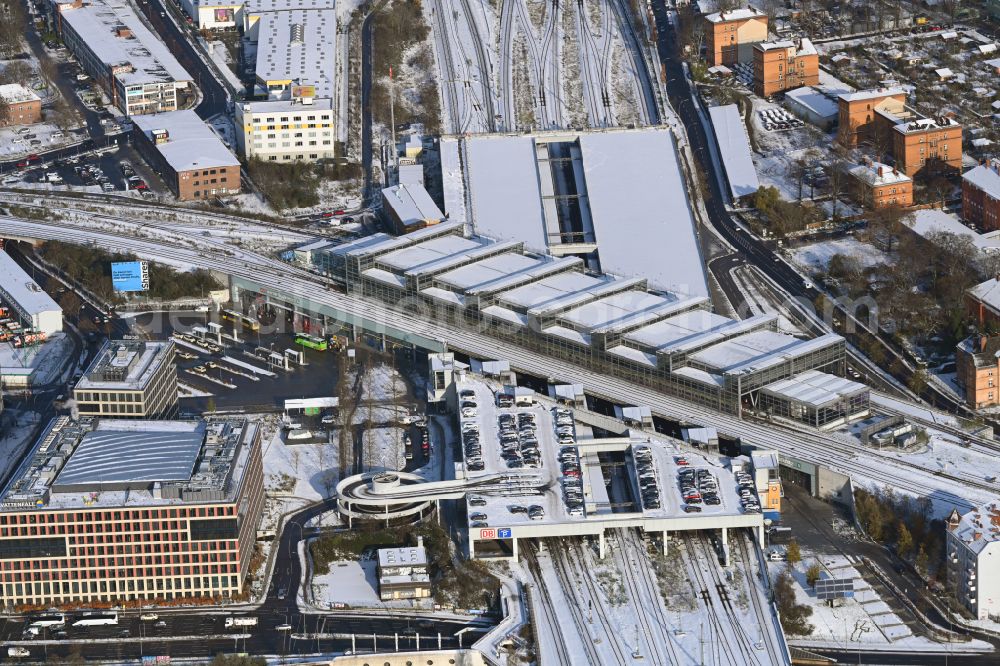 Berlin from the bird's eye view: Wintry snowy station building and track systems of the S-Bahn station Berlin Suedkreuz in the district Tempelhof-Schoeneberg in Berlin, Germany