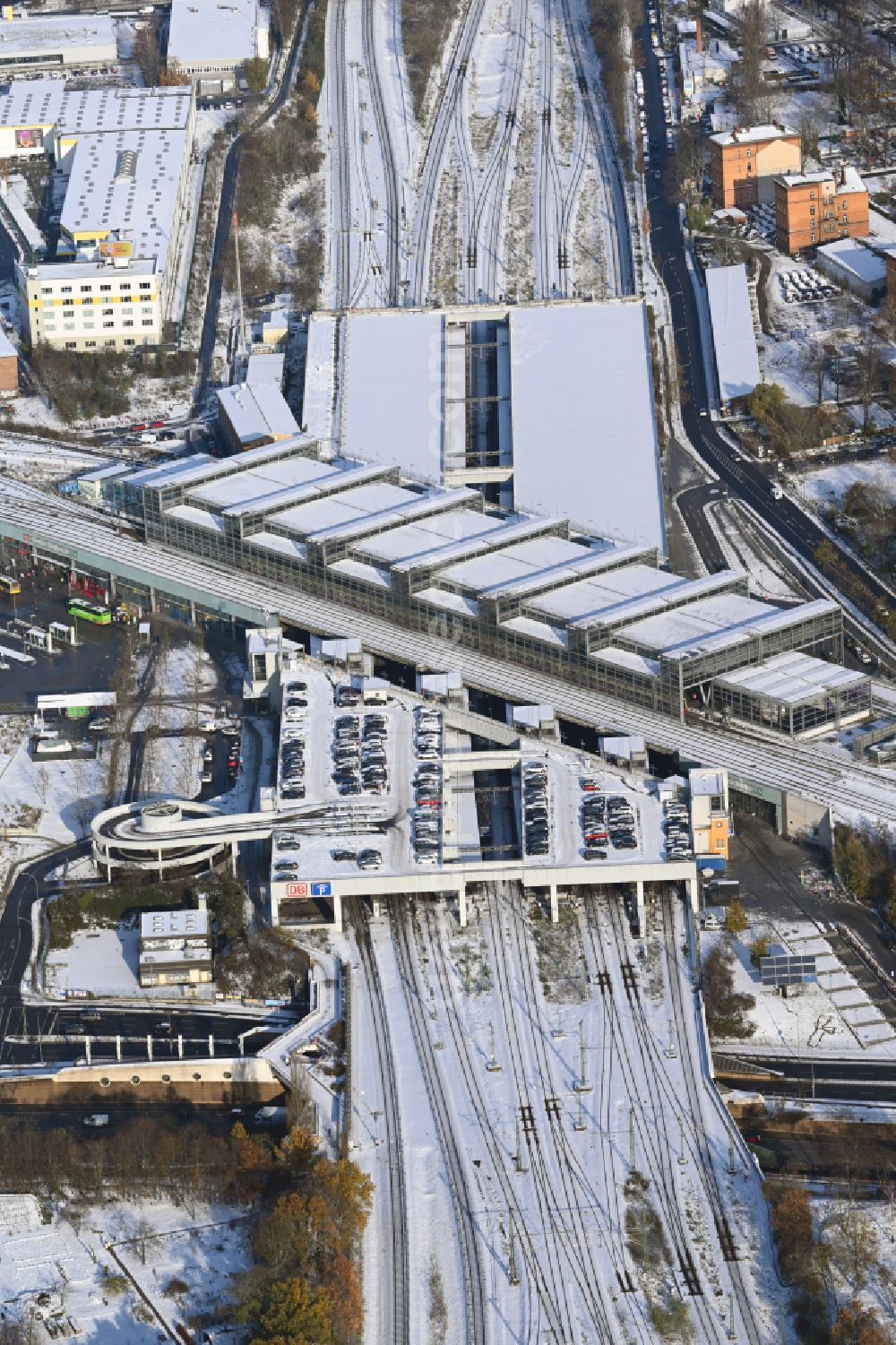 Aerial image Berlin - Wintry snowy station building and track systems of the S-Bahn station Berlin Suedkreuz in the district Tempelhof-Schoeneberg in Berlin, Germany