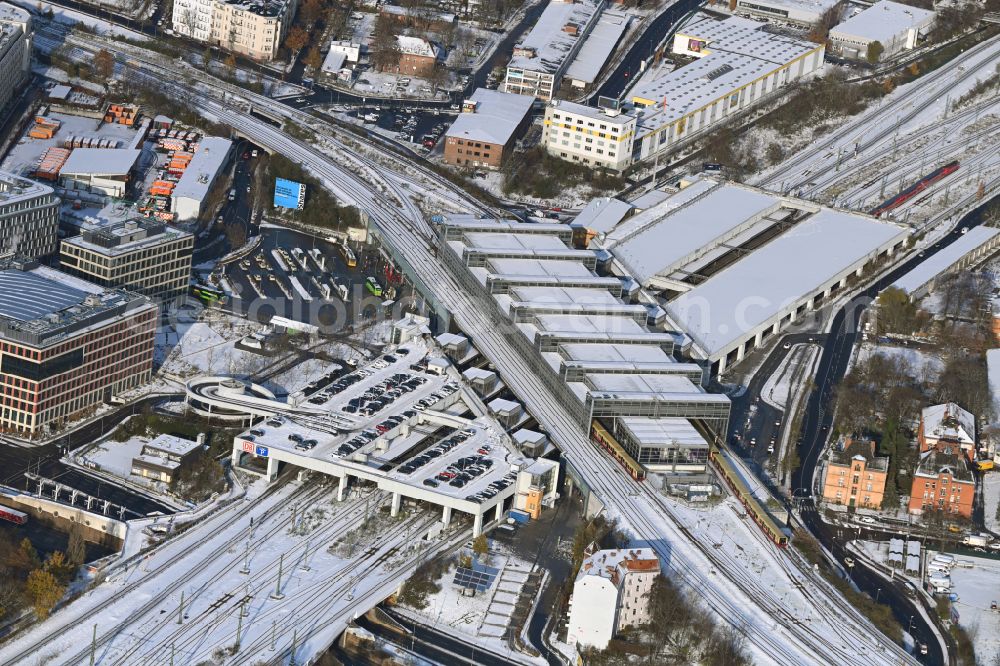 Aerial photograph Berlin - Wintry snowy station building and track systems of the S-Bahn station Berlin Suedkreuz in the district Tempelhof-Schoeneberg in Berlin, Germany