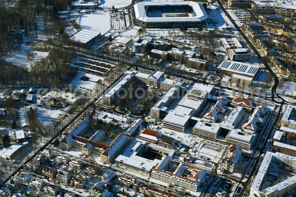 Aerial image Rostock - Wintry snowy construction site company Schaelerbau for the new building of a functional building at the Campus Schillingallee in the district Hansaviertel in Rostock in the state Mecklenburg - Western Pomerania