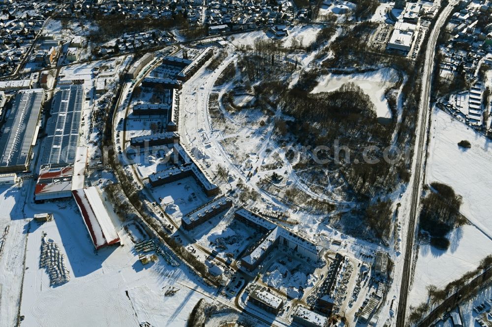 Aerial photograph Bernau - Wintry snowy construction site for the renovation and reconstruction of the building complex of the former military barracks redevelopment area Panke-Park on Schoenfelder Weg in Bernau in the state Brandenburg, Germany