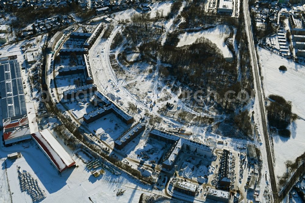 Bernau from above - Wintry snowy construction site for the renovation and reconstruction of the building complex of the former military barracks redevelopment area Panke-Park on Schoenfelder Weg in Bernau in the state Brandenburg, Germany