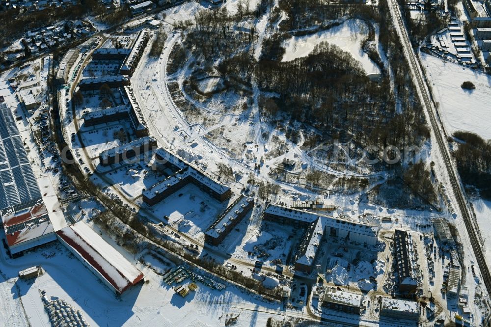 Bernau from the bird's eye view: Wintry snowy construction site for the renovation and reconstruction of the building complex of the former military barracks redevelopment area Panke-Park on Schoenfelder Weg in Bernau in the state Brandenburg, Germany