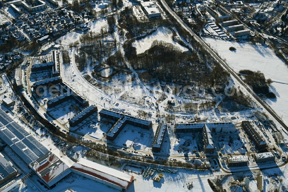 Aerial photograph Bernau - Wintry snowy construction site for the renovation and reconstruction of the building complex of the former military barracks redevelopment area Panke-Park on Schoenfelder Weg in Bernau in the state Brandenburg, Germany