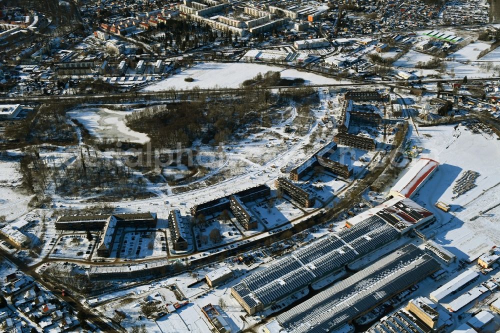 Bernau from the bird's eye view: Wintry snowy construction site for the renovation and reconstruction of the building complex of the former military barracks redevelopment area Panke-Park on Schoenfelder Weg in Bernau in the state Brandenburg, Germany