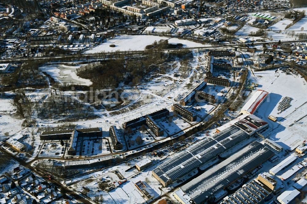 Aerial image Bernau - Wintry snowy construction site for the renovation and reconstruction of the building complex of the former military barracks redevelopment area Panke-Park on Schoenfelder Weg in Bernau in the state Brandenburg, Germany