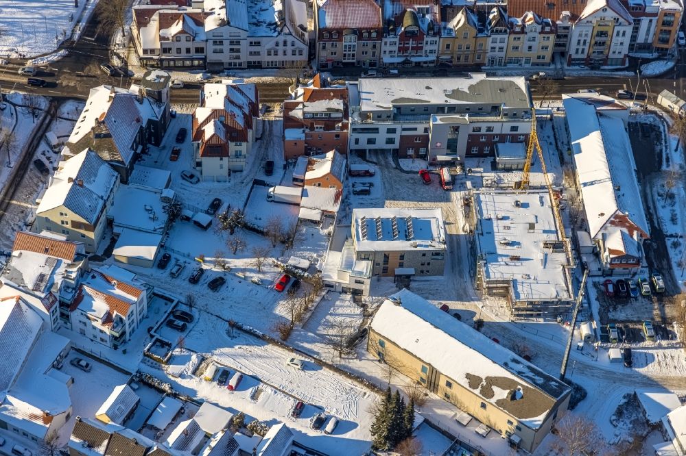 Aerial image Werl - Wintry snowy construction site of the new buildings of the retirement home - retirement Caritas Sozialstation Werl on street Bahnhofstrasse in Werl in the state North Rhine-Westphalia, Germany