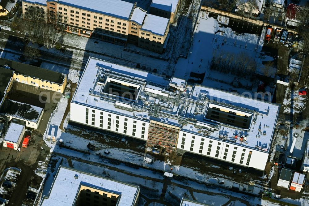 Aerial photograph Berlin - Wintry snowy construction site of a new build retirement home of Vivantes Forum fuer Senioren GmbH on Muensterberger Weg in the district Kaulsdorf in Berlin, Germany