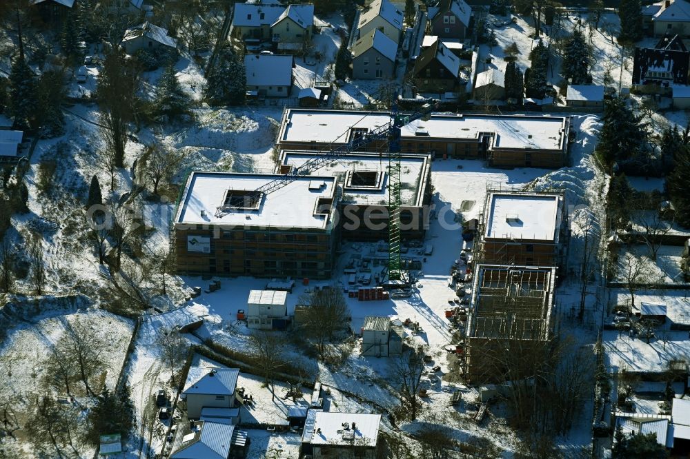 Berlin from above - Wintry snowy construction site of a new build retirement home on Wernergraben corner Sudermannstrasse in the district Mahlsdorf in Berlin, Germany