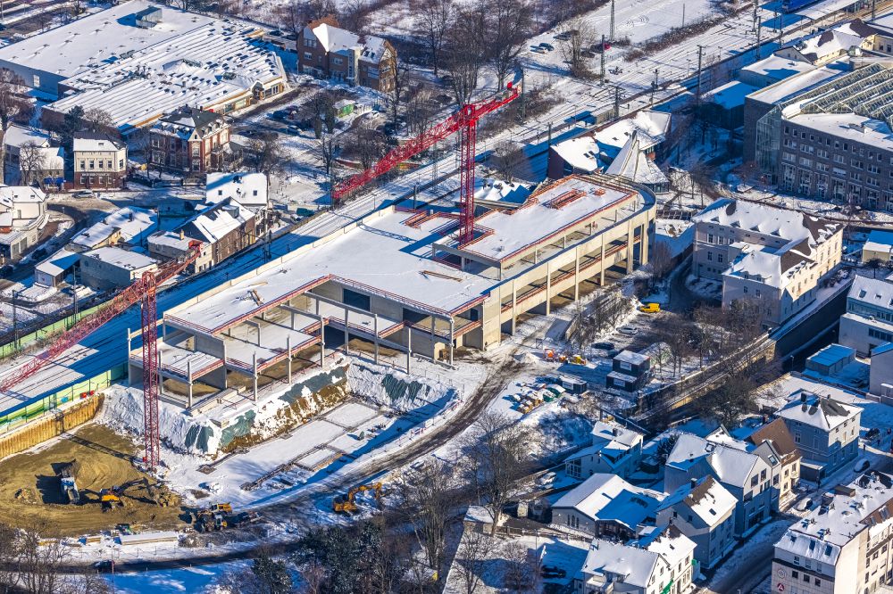Unna from the bird's eye view: Wintry snowy New construction of the building complex of the shopping center on Bahnhofstrasse - Kantstrasse in the district Alte Heide in Unna at Ruhrgebiet in the state North Rhine-Westphalia, Germany