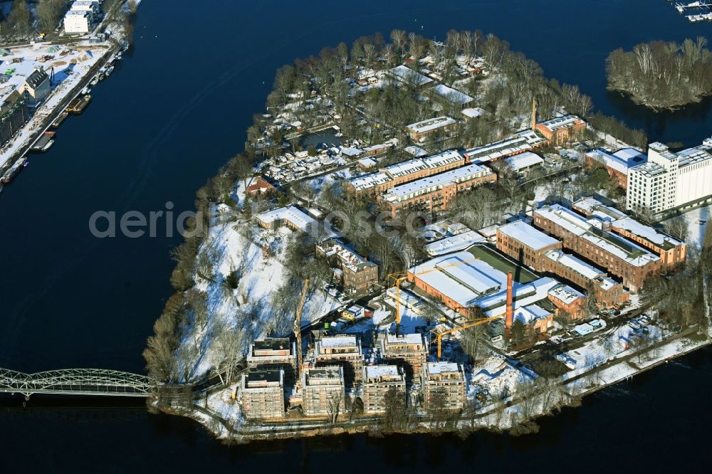 Berlin from above - Wintry snowy construction site for the construction of an apartment building on the Havel island of Eiswerder in the district of Hakenfelde in Berlin, Germany