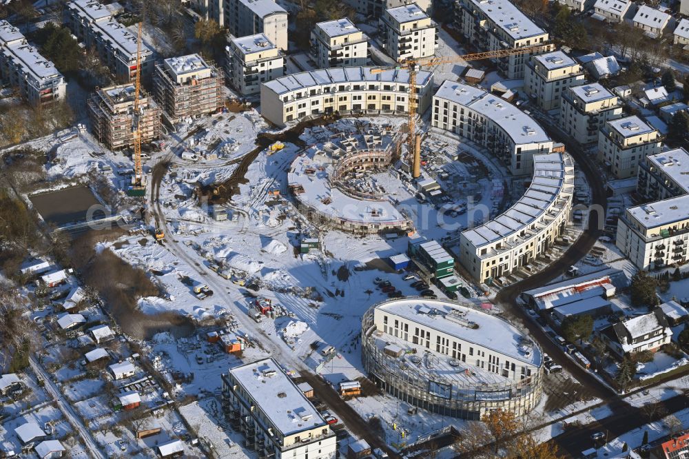 Berlin from the bird's eye view: Wintry snowy construction site to build a new multi-family residential complex HUGOS of Bonava Deutschland GmbH on Britzer Strasse in the district Mariendorf in Berlin, Germany
