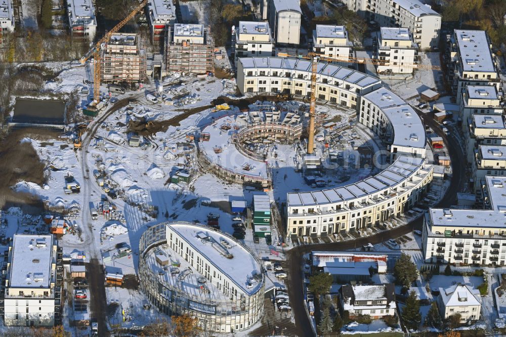 Aerial image Berlin - Wintry snowy construction site to build a new multi-family residential complex HUGOS of Bonava Deutschland GmbH on Britzer Strasse in the district Mariendorf in Berlin, Germany