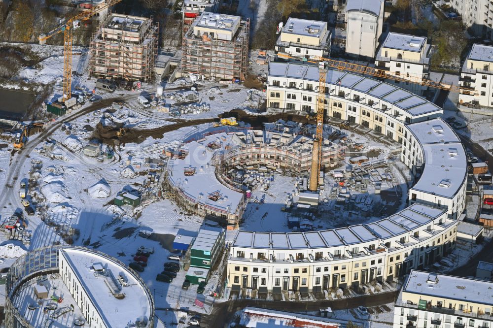 Aerial photograph Berlin - Wintry snowy construction site to build a new multi-family residential complex HUGOS of Bonava Deutschland GmbH on Britzer Strasse in the district Mariendorf in Berlin, Germany