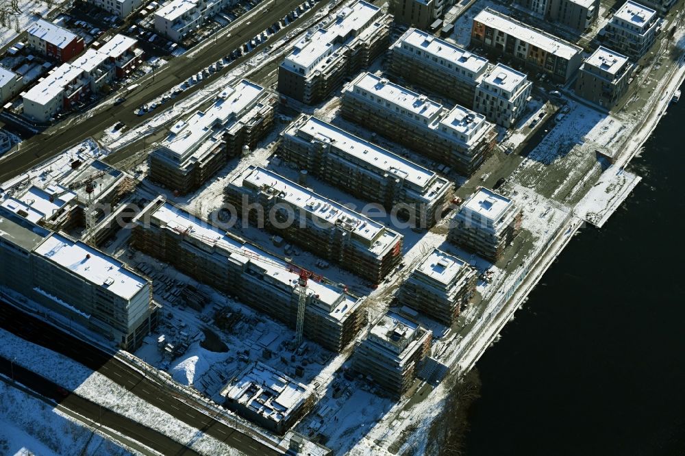 Aerial image Berlin - Wintry snowy residential construction site with multi-family housing development - new building Waterkant on Daumstrasse in the district Haselhorst in Berlin, Germany