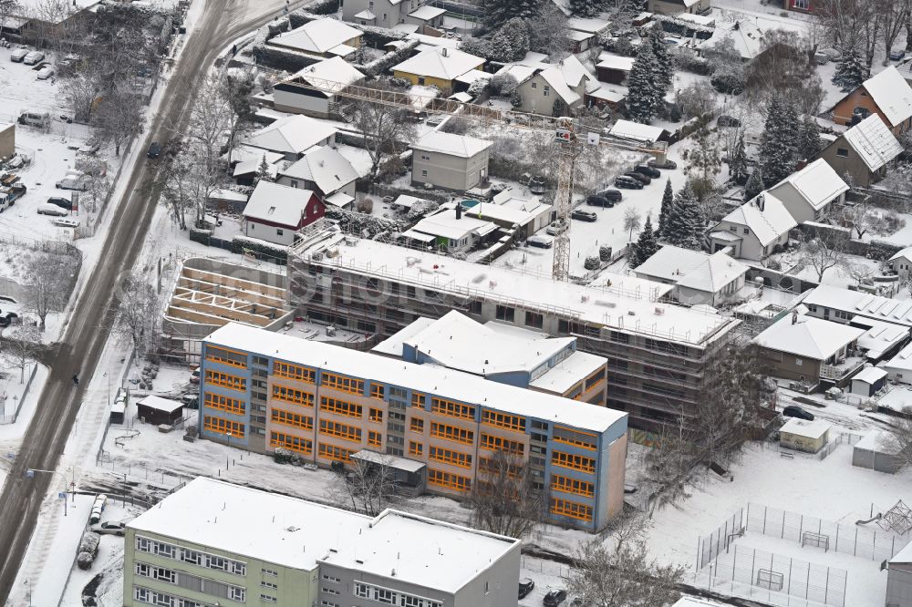 Aerial image Bernau - Wintry snowy new construction site of the school building Grundschule on Hasenheide on street Schoenfelder Weg in Bernau in the state Brandenburg, Germany